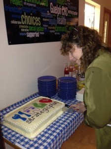 Advance Your Voice speaker, Tina Brophey, cuts the cake at our Strategic Plan Launch.